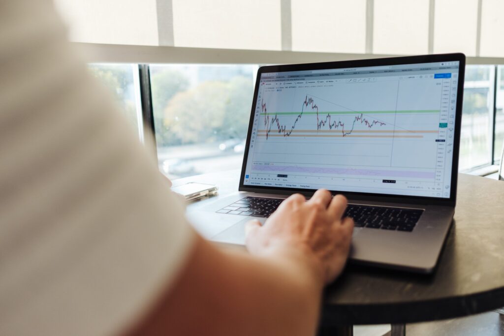 A person analyzing a chart on a laptop, focused on data interpretation and insights.