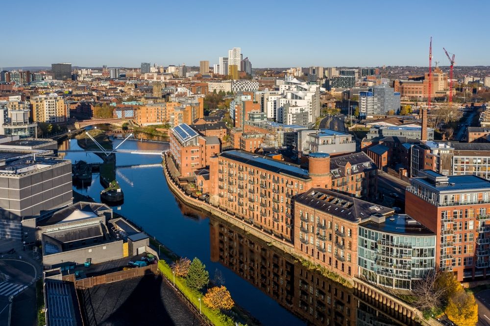 Aerial view of Manchester, showcasing the city's skyline and urban landscape from a high vantage point.