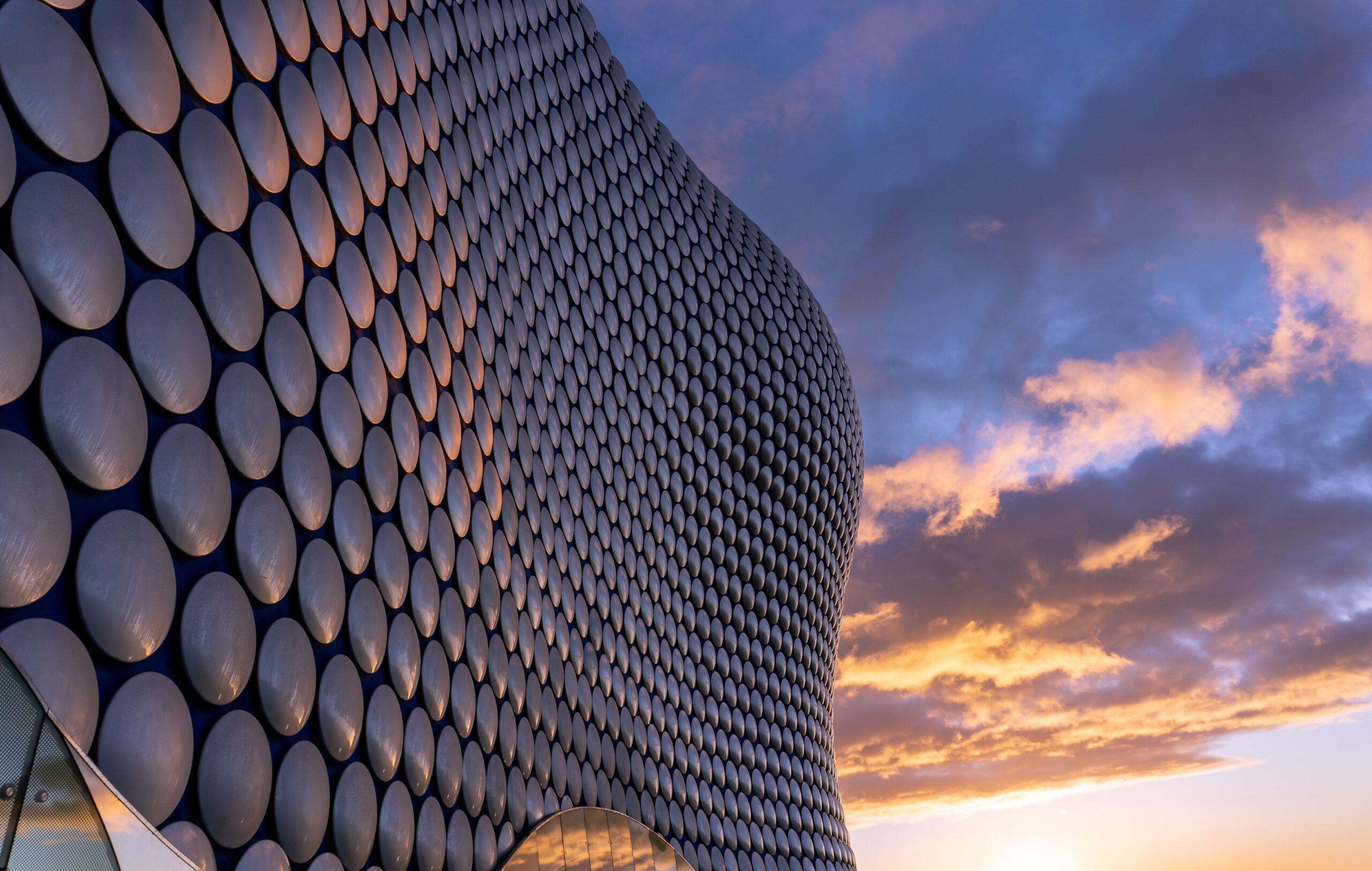 A view of the Selfridges building in Birmingham, England, featuring its iconic design and unique reflective surface.